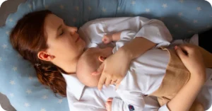 mom asleep with newborn baby